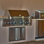 outdoor kitchen with grill, fridge and sink